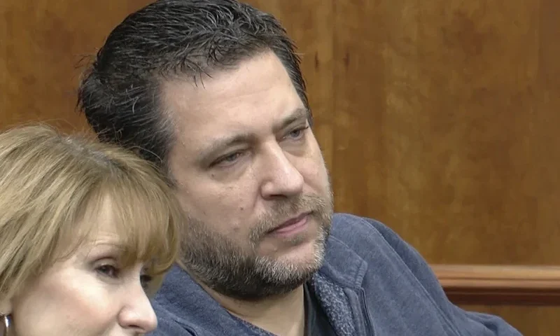 This image taken from video provided by WTVG shows Pastor of Dad's Place Chris Avell, right, sitting inside Bryan Municipal Court on Thursday, Jan. 11, 2024, in Bryan, Ohio. The Christian church filed a federal lawsuit Monday, Jan. 22, after being charged with violating the zoning laws in the northwestern Ohio city by opening up the church around-the-clock for homeless residents and others to find shelter. (WTVG via AP)
