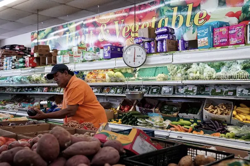 A man shops for produce at Best World Supermarket in the Mount Pleasant neighborhood of Washington, D.C., U.S., August 19, 2022. REUTERS/Sarah Silbiger/File Photo
