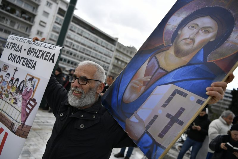 A protester holding a Holy Icon takes part in a rally against same-sex marriage, at central Syntagma Square, in Athens, Greece, Thursday, Feb. 15, 2024. Greece's parliament is to vote Thursday to legalize same-sex civil marriage in a first for an Orthodox Christian country and despite opposition from the influential Greek Church. (AP Photo/Michael Varaklas)
