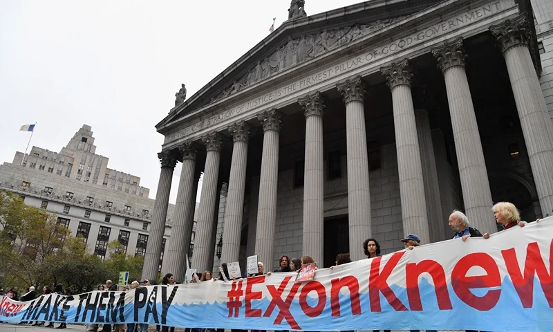 Climate activists protest on the fist day of the ExxonMobil trial outside the New York State Supreme Court building on October 22, 2019 in New York City. (Photo by Angela Weiss / AFP) (Photo by ANGELA WEISS/AFP via Getty Images)