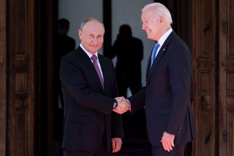 Russian President Vladimir Putin (L) shakes hands with US President Joe Biden prior to the US-Russia summit at the Villa La Grange, in Geneva on June 16, 2021. (Photo by Brendan Smialowski / AFP) (Photo by BRENDAN SMIALOWSKI/AFP via Getty Images)
