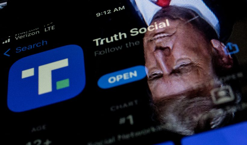 This photo illustration shows an image of former President Donald Trump reflected in a phone screen that is displaying the Truth Social app, in Washington, DC, on February 21, 2022. - Donald Trump's new social media app started a gradual rollout late February 21st and should be "fully operational" by late March, potentially raising the former president's profile more than a year after he was banned by major platforms. Trump has described Truth Social as an alternative to Facebook, Twitter and YouTube, all of which banned him following the assault on the US Capitol by his supporters on January 6, 2021. The former president has been accused of inciting his followers to use force in a bid to overturn the result of the 2020 election. (Photo by Stefani Reynolds / AFP) (Photo by STEFANI REYNOLDS/AFP via Getty Images)