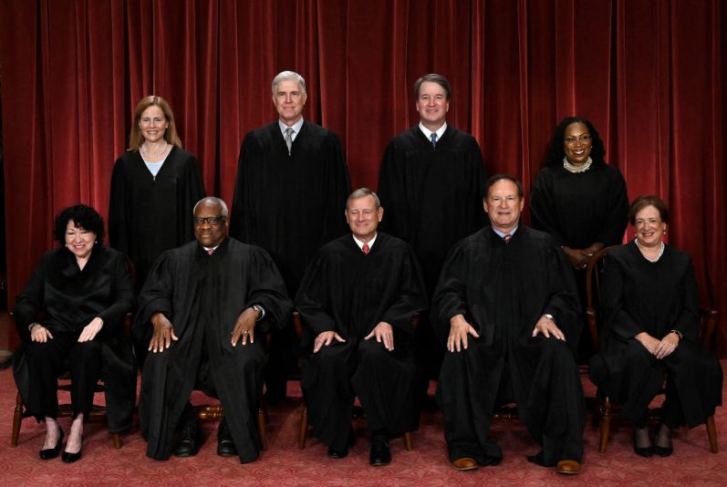 TOPSHOT - Justices of the US Supreme Court pose for their official photo at the Supreme Court in Washington, DC on October 7, 2022. (Seated from left) Associate Justice Sonia Sotomayor, Associate Justice Clarence Thomas, Chief Justice John Roberts, Associate Justice Samuel Alito and Associate Justice Elena Kagan, (Standing behind from left) Associate Justice Amy Coney Barrett, Associate Justice Neil Gorsuch, Associate Justice Brett Kavanaugh and Associate Justice Ketanji Brown Jackson. (Photo by OLIVIER DOULIERY / AFP) (Photo by OLIVIER DOULIERY/AFP via Getty Images)