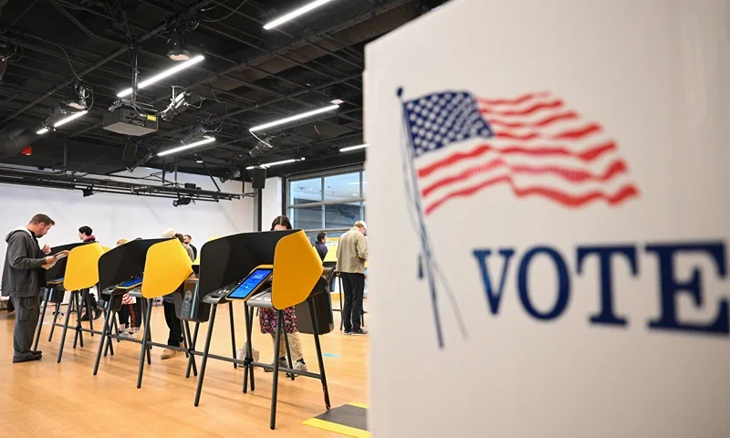People cast ballots on electronic voting machines for the midterm election during early voting ahead of Election Day inside a vote center at the Hammer Museum in Los Angeles, California on November 7, 2022. (Photo by Patrick T. FALLON / AFP) (Photo by PATRICK T. FALLON/AFP via Getty Images)
