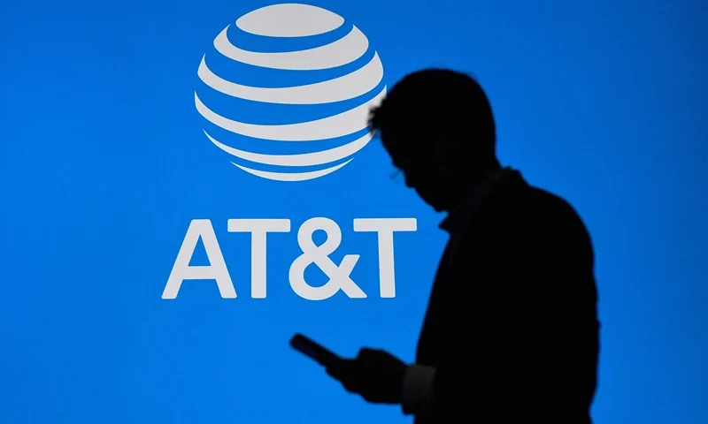 SPAIN-TELECOM-TECHNOLOGY A visitor walks past US multinational telecommunications AT&T logo at the Mobile World Congress (MWC), the telecom industry's biggest annual gathering, in Barcelona on February 27, 2023. (Photo by Pau BARRENA / AFP) (Photo by PAU BARRENA/AFP via Getty Images)