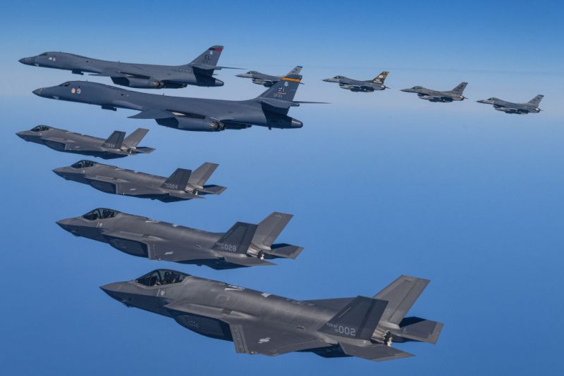 UNDISCLOSED LOCATION, SOUTH KOREA - MARCH 19: In this handout image released by the South Korean Defense Ministry, two U.S. Air Force B-1B bombers (top L) flying over South Korea with South Korean Air Force F-35A (L) and U.S. Air Force F-16 (top R) fighter jets during a combined air drill on March 19, 2023 at an undisclosed location in South Korea. U.S. B-1B strategic bomber returned to South Korea for combined exercises as North Korea fired yet another ballistic missile into the East Sea, according to the defense ministry. (Photo by South Korean Defense Ministry via Getty Images)