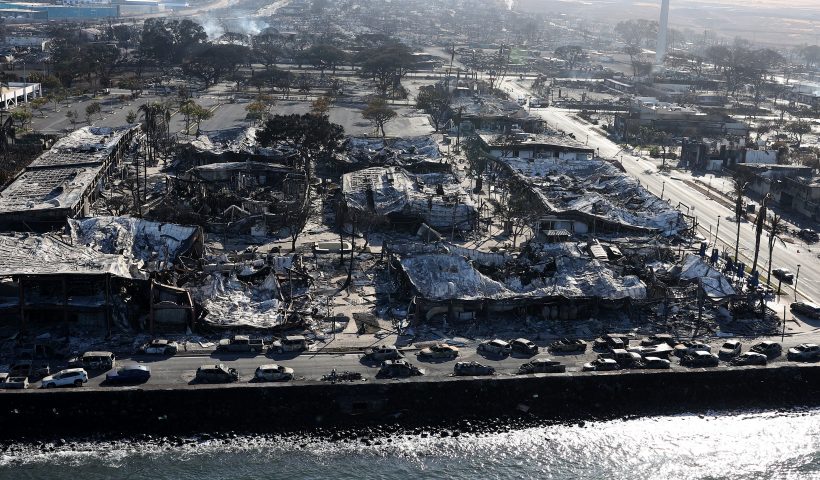 LAHAINA, HAWAII - AUGUST 11: In an aerial view, cars destroyed by wildfire line Front Street on August 11, 2023 in Lahaina, Hawaii. Dozens of people were killed and thousands were displaced after a wind-driven wildfire devastated the town of Lahaina on Tuesday. Crews are continuing to search for missing people. (Photo by Justin Sullivan/Getty Images)