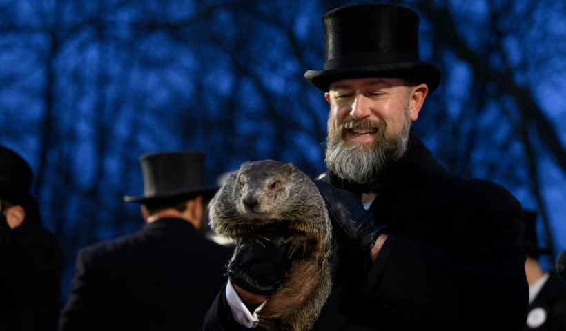 PUNXSUTAWNEY, PA - FEBRUARY 2: Groundhog handler AJ Dereume holds Punxsutawney Phil after he did not see his shadow predicting an early Spring during the 138th annual Groundhog Day festivities on Friday February 2, 2024 in Punxsutawney, Pennsylvania. Groundhog Day is a popular tradition in the United States and Canada. Over 40,000 people spent a night of revelry awaiting the sunrise and the groundhog's exit from his winter den. If Punxsutawney Phil sees his shadow he regards it as an omen of six more weeks of bad weather and returns to his den. Early spring arrives if he does not see his shadow, causing Phil to remain above ground. (Photo by Jeff Swensen/Getty Images)