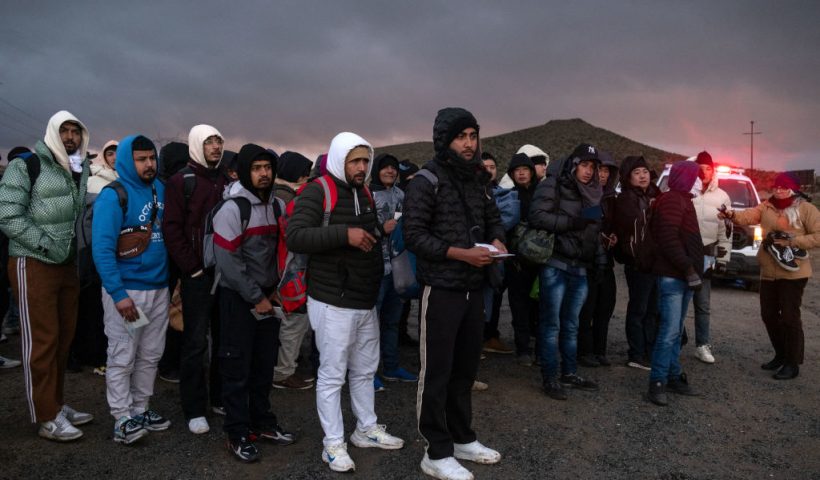 Asylum seekers wait in line to be processed by the Border Patrol at a makeshift camp near the US-Mexico border east of Jacumba, San Diego County, California, January 2, 2024. (Photo by Guillermo Arias / AFP) (Photo by GUILLERMO ARIAS/AFP via Getty Images)