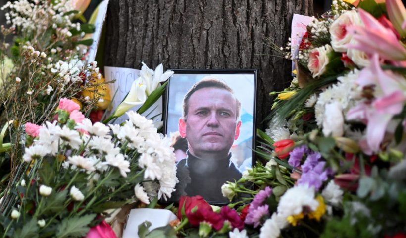 This photograph taken on February 16, 2024, shows a portrait of Alexei Navalny displayed amongst flowers as protestors pay their respects outside the Russian Embassy in Belgrade, following the news of Russian opposition leader and political activist Alexei Navalny's death at the Arctic prison where he was serving a 19-year-term. (Photo by OLIVER BUNIC / AFP) (Photo by OLIVER BUNIC/AFP via Getty Images)