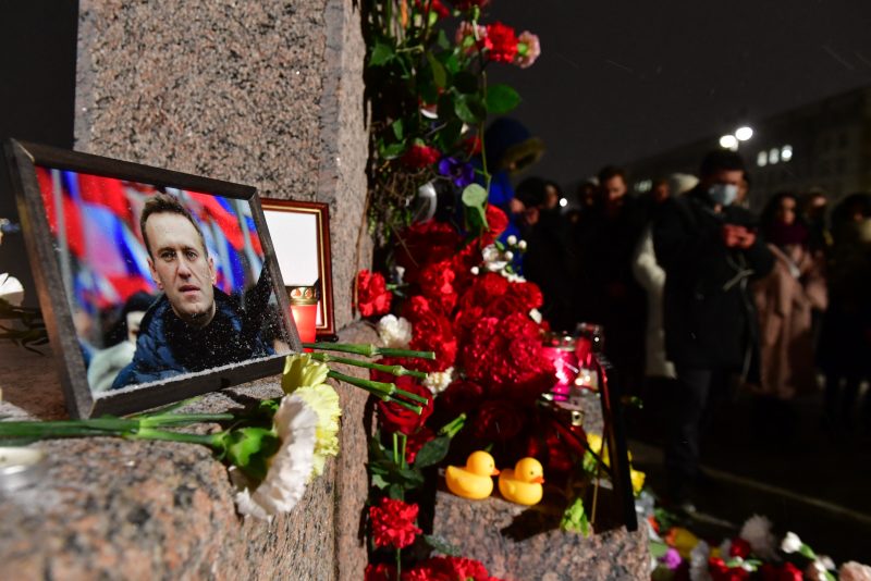 TOPSHOT - People gather at a makeshift memorial for late Russian opposition leader Alexei Navalny organized at the monument to the victims of political repressions in Saint Petersburg on February 16, 2024, following Navalny's death in his Arctic prison. (Photo by Olga MALTSEVA / AFP) (Photo by OLGA MALTSEVA/AFP via Getty Images)