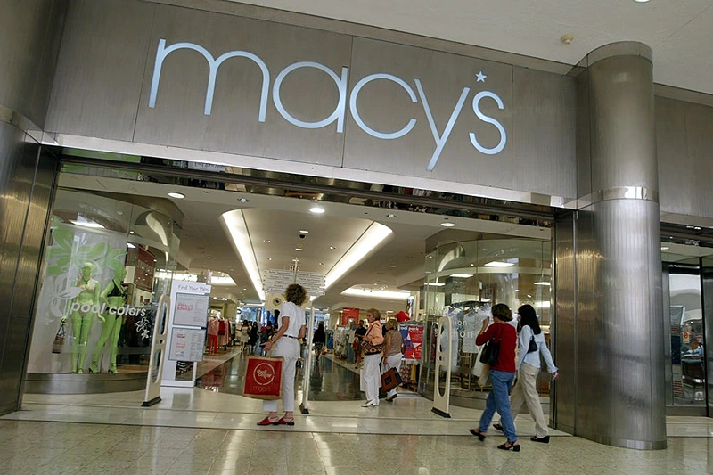 NORTH MIAMI, FL - MAY 23:  Customers walk out of Macy's the day after the company announced that the 56 Burdines stores and the seven Macy's stores in Florida all will operate under the combined name of Burdines-Macy's May 23, 2003 in North Miami, Florida. The union is part of a strategy by parent company Federated Department Stores to use the national marketing clout of the Macy's name and take advantage of larger buying power. All of Federated's regional department store chains will make similar moves. The Miami-based Burdines will actually be the last one to be converted to the same name.  (Photo by Joe Raedle/Getty Images)