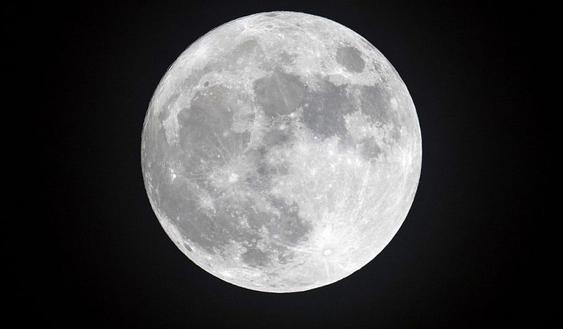 PENZANCE, ENGLAND - DECEMBER 13: Clouds clear to allow a view of the final full moon of the year, a so-called 'Cold Moon', as it appears behind lights illuminating Penzance seafront on December 13, 2016 in Cornwall, England. The last full moon of the year was also the final supermoon of 2016. The natural phenomenon occurs when the perigee (closest approach by the Moon to Earth) coincides with it being full (completely illuminated by the Sun). (Photo by Matt Cardy/Getty Images)
