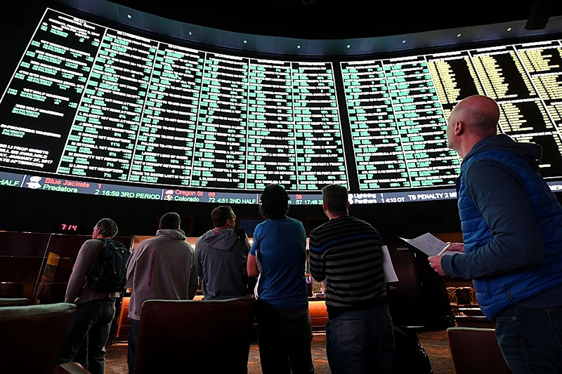 LAS VEGAS, NV - JANUARY 26:  Bettors line up to place wagers after more than 400 proposition bets for Super Bowl LI between the Atlanta Falcons and the New England Patriots were posted at the Race & Sports SuperBook at the Westgate Las Vegas Resort & Casino on January 26, 2017 in Las Vegas, Nevada.  (Photo by Ethan Miller/Getty Images)