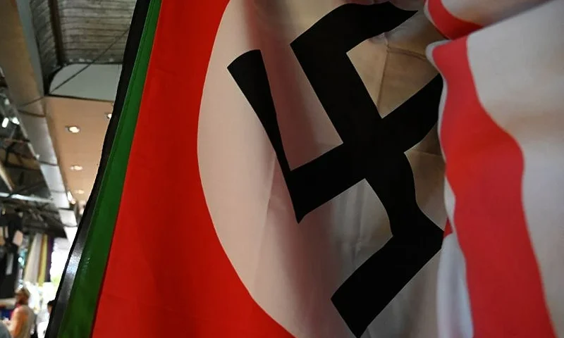 This photo taken on March 2, 2019 shows a Nazi flag for sale at a weekend market in Bangkok. As Europe battles a surge in anti-Semitism, including the desecration of graves in France, Southeast Asia is wrestling with a lack of understanding about the provenance of Nazi paraphernalia that casually creeps into public spaces. (Photo by Lillian SUWANRUMPHA / AFP) / TO GO WITH STORY Southeast Asia-Nazi-regalia-education,FOCUS by Joe FREEMAN (Photo by LILLIAN SUWANRUMPHA/AFP via Getty Images)