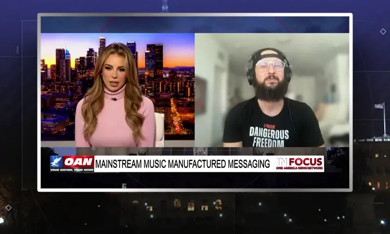 Video still from In Focus on One America News Network showing a split screen of the host on the left side, and on the right side is the guest, Hi-Rez The Rapper.
