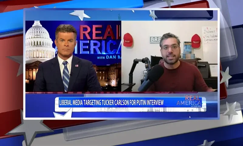 Video still from Real America on One America News Network showing a split screen of the host on the left side, and on the right side is the guest, Raheem Kassam.