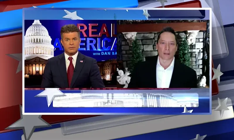 Video still from Real America on One America News Network showing a split screen of the host on the left side, and on the right side is the guest, Dr. Rick Tsai.