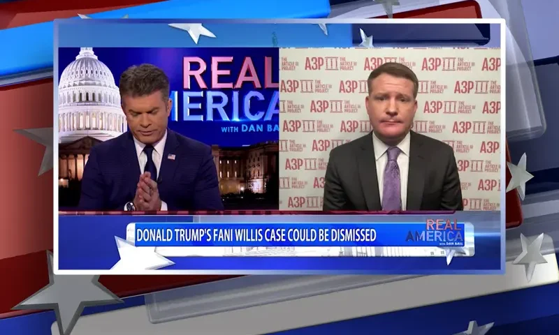 Video still from Real America on One America News Network showing a split screen of the host on the left side, and on the right side is the guest, Mike Davis.