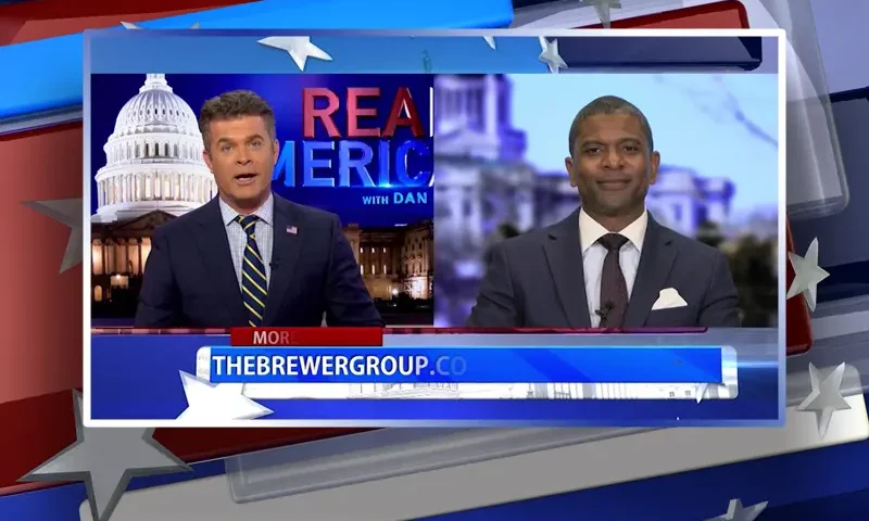 Video still from Real America on One America News Network showing a split screen of the host on the left side, and on the right side is the guest, Jack Brewer.