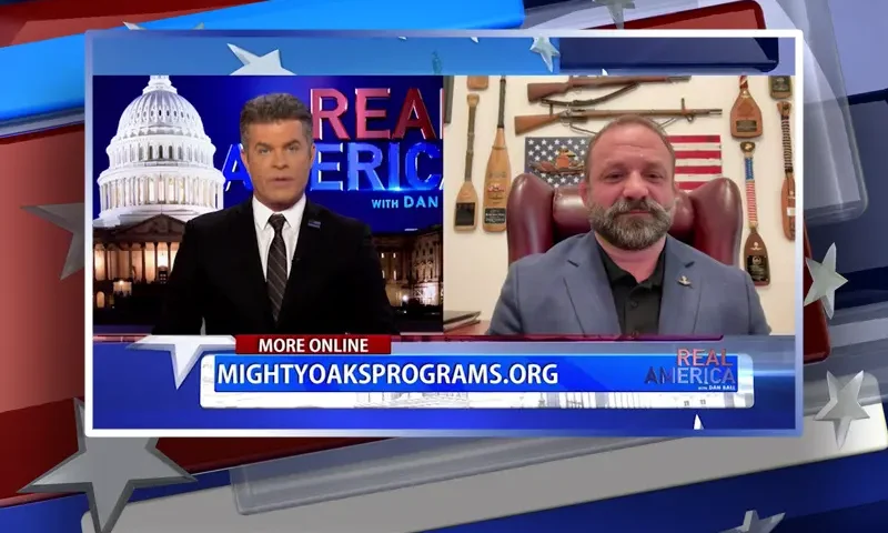 Video still from Real America on One America News Network showing a split screen of the host on the left side, and on the right side is the guest, Chad Robichaux.