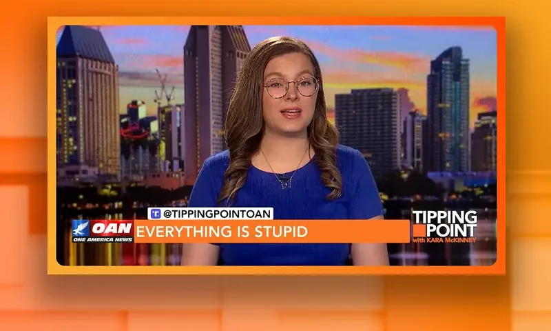 Video still of the host of Tipping Point at the desk of their talk show on One America News Network.