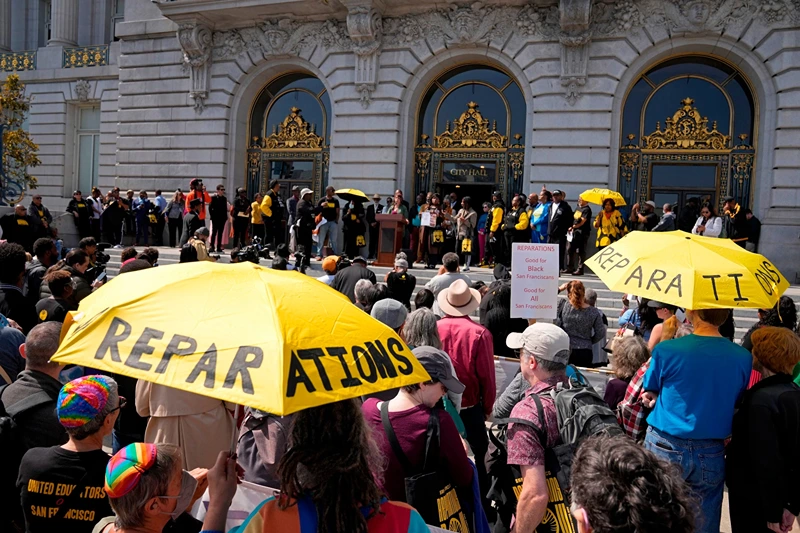 People listen during a rally in support of reparations for African Americans outside City Hall in San Francisco, Sept. 19, 2023.
Eric Risberg/AP