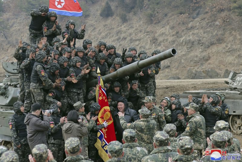 In this photo provided by the North Korean government, North Korean leader Kim Jong Un, center, meets soldiers who took part in a training in North Korea Wednesday, March 13, 2024. Independent journalists were not given access to cover the event depicted in this image distributed by the North Korean government. The content of this image is as provided and cannot be independently verified. Korean language watermark on image as provided by source reads: "KCNA" which is the abbreviation for Korean Central News Agency. (Korean Central News Agency/Korea News Service via AP)