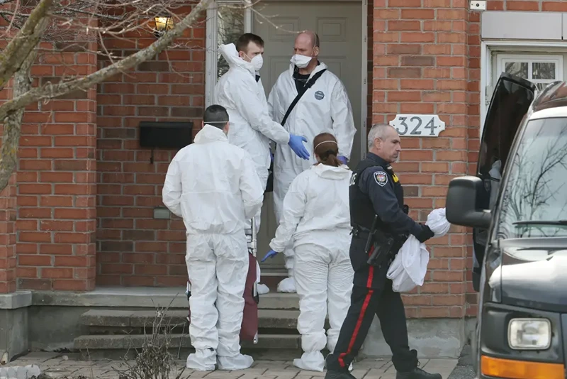 Members of the coroner’s office stand outside the scene of a homicide where six people were found dead in the Barrhaven suburb of Ottawa on Thursday, March 7, 2024.
(Photo via AP/file)