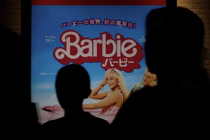 People walk past a promotional poster of film "Barbie" in Tokyo, Japan, August 3, 2023. REUTERS/Kim Kyung-Hoon/File Photo