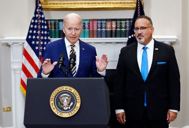 US President Joe Biden announces student loan relief with Education Secretary Miguel Cardona (R) on August 24, 2022 in the Roosevelt Room of the White House in Washington, DC. - Biden announced that most US university graduates still trying to pay off student loans will get $10,000 of relief to address a decades-old headache of massive educational debt across the country. (Photo by OLIVIER DOULIERY / AFP) (Photo by OLIVIER DOULIERY/AFP via Getty Images)