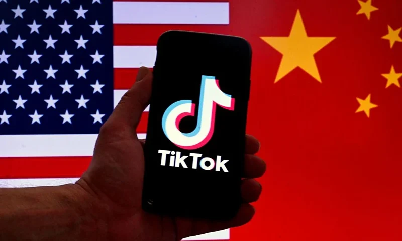 In this photo illustration the social media application logo for TikTok is displayed on the screen of an iPhone in front of a US flag and Chinese flag background in Washington, DC, on March 16, 2023. China urged the United States to stop "unreasonably suppressing" TikTok on March 16, 2023, after Washington gave the popular video-sharing app an ultimatum to part ways with its Chinese owners or face a nationwide ban. (Photo by OLIVIER DOULIERY / AFP) (Photo by OLIVIER DOULIERY/AFP via Getty Images)