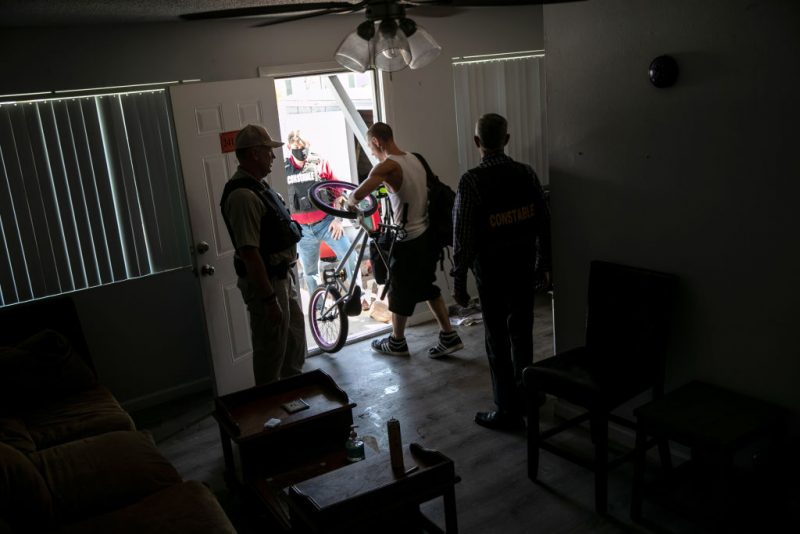 PHOENIX, ARIZONA - SEPTEMBER 30: A squatter removes belongings from an apartment as Maricopa County constables serve an eviction order on September 30, 2020 in Phoenix, Arizona. Squatters had occupied the apartment after non-paying tenants had moved out. Thousands of court-ordered evictions continue nationwide despite a Centers for Disease Control (CDC) moratorium for renters impacted by the coronavirus pandemic. Although state and county officials say they have tried to educate the public on the protections, many renters remain unaware and fail to complete the necessary forms to remain in their homes. In many cases landlords have worked out more flexible payment plans with vulnerable tenants, although these temporary solutions have become fraught as the pandemic drags on. With millions of Americans still unemployed due to the pandemic, federal rental assistance proposals remain gridlocked in Congress. The expiry of the CDC moratorium at year's end looms large, as renters and landlord face a potential tsunami of evictions and foreclosures nationwide. (Photo by John Moore/Getty Images)
