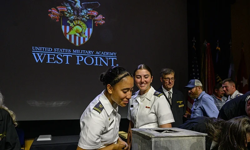People look into a nearly 200-year-old time capsule during a ceremony in the Robinson Auditorium at Thayer Hall of the US Military Academy in West Point, New York, on August 28, 2023. The sealed lead time capsule measuring about one square foot was discovered in the Thaddeus Kosciuszko monument's base during recent renovations. Academy officials determined the capsule was placed in the base of the Kosciuszko monument 26 years after the academy's founding by cadets in 1828. The capsule was found to be mostly empty other than grey sediment. (Photo by Ed JONES / AFP) (Photo by ED JONES/AFP via Getty Images)