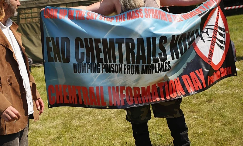WATFORD, ENGLAND - JUNE 06: A man demonstrates against "Chemtrails" in a protester encampment outside The Grove hotel, which is hosting the annual Bilderberg conference, on June 6, 2013 in Watford, England. The traditionally secretive conference, which has taken place since 1954, is expected to be attended by politicians, bank bosses, businessman and European royalty. (Photo by Oli Scarff/Getty Images)