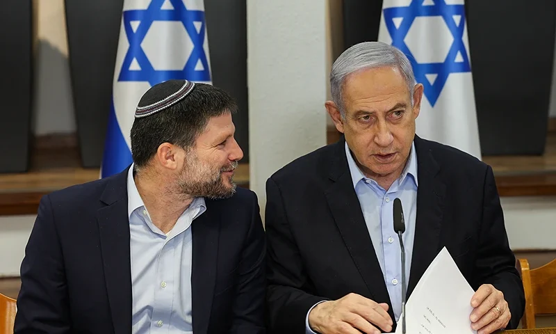 Israeli Prime Minister Benjamin Netanyahu (R) and Minister of Finance Bezalel Smotrich attend the weekly cabinet meeting at the Defence Ministry in Tel Aviv on January 7, 2024. (Photo by RONEN ZVULUN / POOL / AFP) (Photo by RONEN ZVULUN/POOL/AFP via Getty Images)