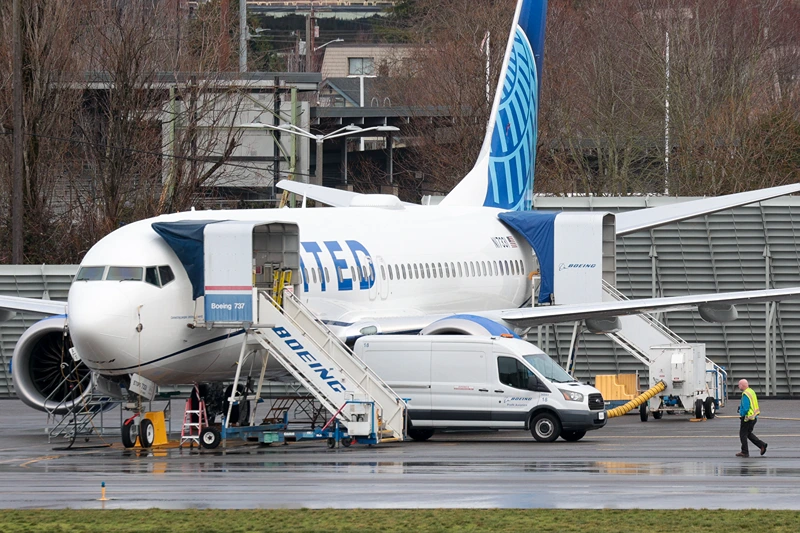 TOPSHOT-US-ACCIDENT-AVIATION-BOEING
TOPSHOT - A person walks past a Boeing 737 MAX 8 for United Airlines parked at Renton Municipal Airport adjacent to Boeing's factory in Renton, Washington, on January 25, 2024. Alaska Airlines said Thursday it expects a $150 million hit from the Boeing 737 MAX grounding, which will limit its capacity growth in 2024. The airline, which executed an emergency landing on a MAX on January 5 following the mid-flight blowout of a panel on the jet, disclosed the estimates in a securities filing, saying capacity growth will be "at or below the lower end" of its prior estimate. (Photo by Jason Redmond / AFP) (Photo by JASON REDMOND/AFP via Getty Imag