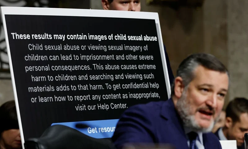 WASHINGTON, DC - JANUARY 31: An aide holds up a poster as Sen. Ted Cruz (R-TX) speaks during a Senate Judiciary Committee hearing at the Dirksen Senate Office Building on January 31, 2024 in Washington, DC. The committee heard testimony from the heads of the largest tech firms on the dangers of child sexual exploitation on social media. (Photo by Anna Moneymaker/Getty Images)