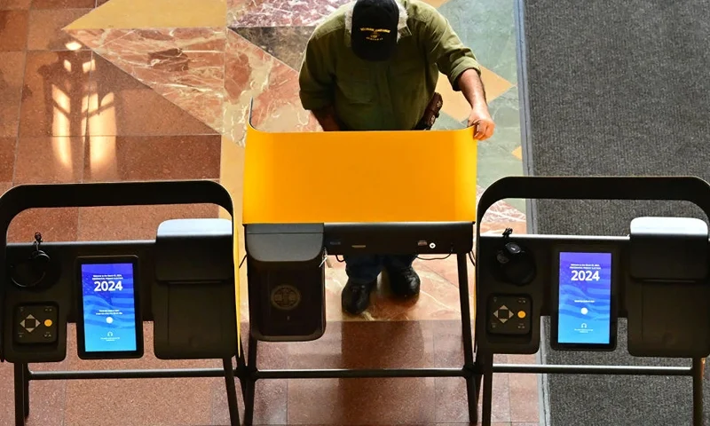A man casts his ballot during early voting at a polling location at Union Station in Los Angeles, California, on March 4, 2024 ahead of the California Primary election on "Super Tuesday," March 5. Americans from 15 states and one territory vote on "Super Tuesday," a campaign calendar milestone expected to leave former US President and 2024 presidential hopeful Donald Trump a hair's breadth from securing the Republican Party's presidential nomination. (Photo by Frederic J. BROWN / AFP) (Photo by FREDERIC J. BROWN/AFP via Getty Images)