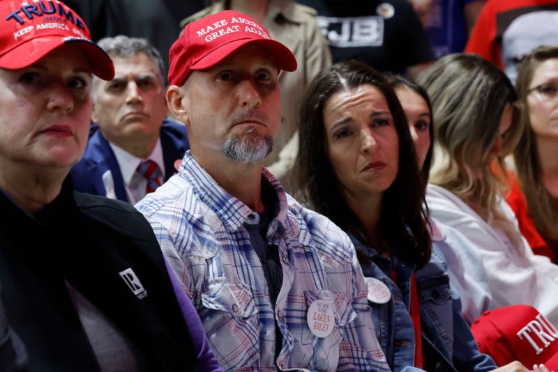 ROME, GEORGIA - MARCH 09: Laken Riley's parents Jason Riley (C) and Allyson Philips attend Republican presidential candidate and former U.S. President Donald Trump's campaign rally at the Forum River Center March 09, 2024 in Rome, Georgia. Laken Riley, 22, was a University of Georgia student who was murdered on February 22 and police have arrested an undocumented immigrant for the crime. Both Trump and President Joe Biden are holding campaign events on Saturday in Georgia, a critical battleground state, two days before the its primary elections. A city of about 38,000, Rome is in the heart of conservative northwest Georgia and the center of the Congressional district represented by Rep. Majorie Taylor Green (R-GA). (Photo by Chip Somodevilla/Getty Images)