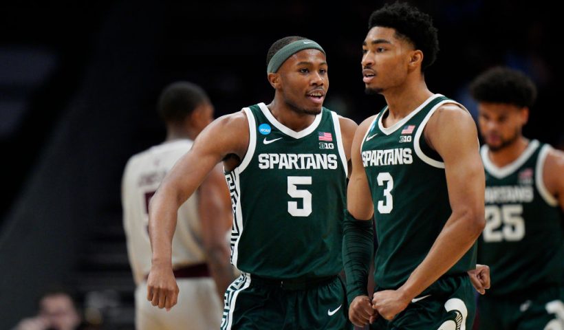 Tre Holloman #5 and Jaden Akins #3 of the Michigan State Spartans celebrate a basket against the Mississippi State Bulldogs during the second half in the first round of the NCAA Men's Basketball Tournament at Spectrum Center on March 21, 2024 in Charlotte, North Carolina. (Photo by Jacob Kupferman/Getty Images)
