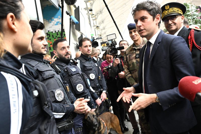 French Prime Minister Gabriel Attal (2nd R) speaks with French SNCF railway's security staff during a visit to the Saint-Lazare railway station in Paris on March 25, 2024. Four months ahead of the Paris 2024 Olympic Games, French authorities has raised the maximum alert level for terrorist threat, after the Moscow attack carried out, according to the French President, by an 