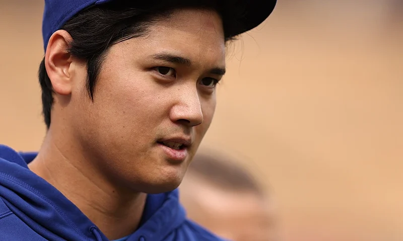 LOS ANGELES, CALIFORNIA - MARCH 25: Shohei Ohtani #17 of the Los Angeles Dodgers reacts as he warms up prior to a game against the Los Angeles Angels at Dodger Stadium on March 25, 2024 in Los Angeles, California. (Photo by Michael Owens/Getty Images)