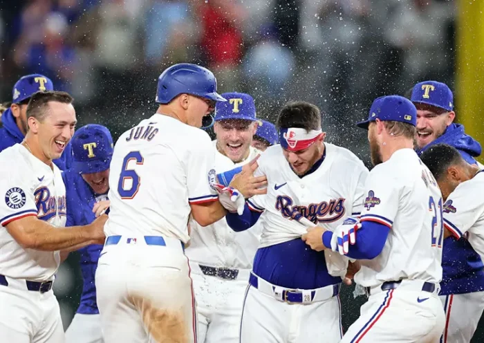 Jonah Heim #28 of the Texas Rangers is congratulated by teammates following a walk-off single in the 11th inning to defeat the Chicago Cubs in the Opening Day game at Globe Life Field on March 28, 2024 in Arlington, Texas. (Photo by Stacy Revere/Getty Images)