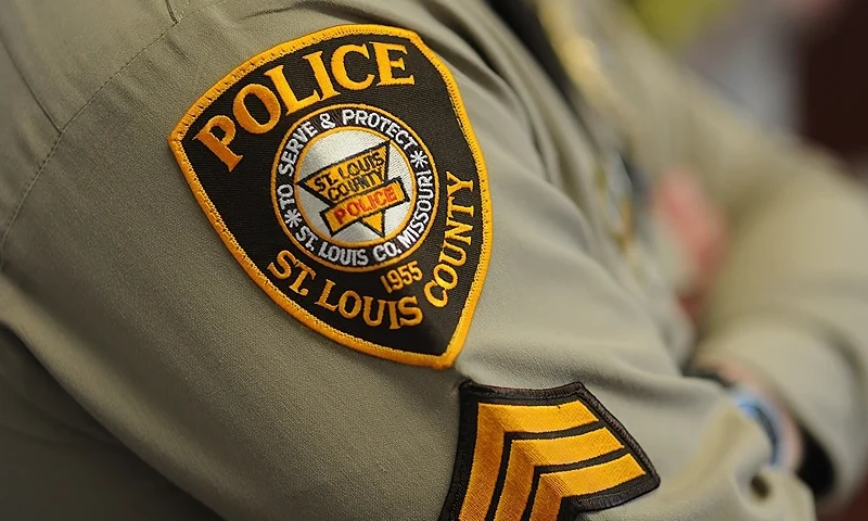 A St. Louis County Police Officer listens during a press conference on March 12, 2015 in Clayton, Missouri. The press conference was held to discuss the overnight shooting of two police officers outside the Ferguson Police Department who were rushed to a local hospital. Two police officers shot overnight in the troubled Missouri city of Ferguson were victims of an "ambush," the police chief of St Louis County said Thursday. AFP PHOTO / MICHAEL B. THOMAS (Photo by Michael B. Thomas/AFP via Getty Images)