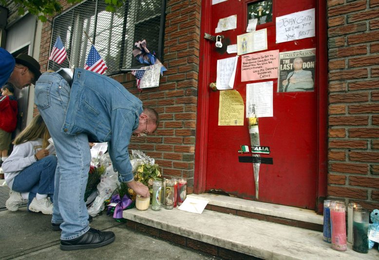 NEW YORK, UNITED STATES: Well-wishers light candles for former mob boss John Gotti outside the Bergin Hunt and Fish Club in Queens, New York 15 June 2002. The former head of the Gambino crime family died of cancer in prison 10 June 2002. Gotti ran business out of the club early in his career. AFP PHOTO/Doug KANTER (Photo credit should read DOUG KANTER/AFP via Getty Images)