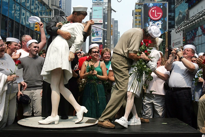 Times Square "Kiss In" Celebrates Famed WWII Photo
NEW YORK - AUGUST 14: Carl Muscarello and Edith Shain, who claim to be the nurse and sailor in the famous photograph taken on V-J Day, kiss next to a sculpture based on the photograph in Times Square to commemorate the 60th anniversary of the end of World War II August 14, 2005 in New York City. Alfred Eisenstaedt took the famous photograph in Times Square but did not note the names of the people in the picture. (Photo by Mario Tama/Getty Images)