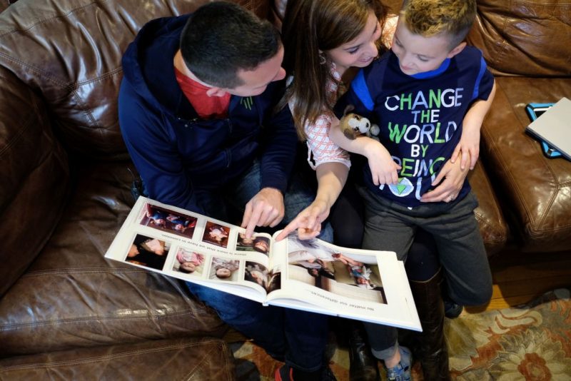 Seven-year-old transgender boy Jacob Lemay and his parents Joe and Mimi look at their family photo before his transition at their home in Melrose, Massachusetts, on May 9, 2017.
