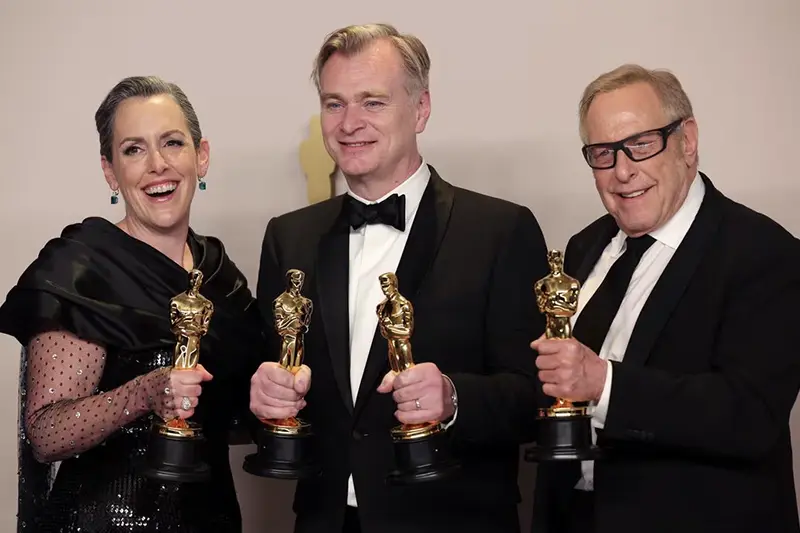 Christopher Nolan, Emma Thomas and Charles Roven pose with the Oscar for Best Picture for "Oppenheimer" in the Oscars photo room at the 96th Academy Awards in Hollywood, Los Angeles, California, U.S., March 10, 2024. REUTERS/Carlos Barria