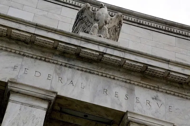 An eagle tops the U.S. Federal Reserve building's facade in Washington, July 31, 2013. REUTERS/Jonathan Ernst/File Photo
